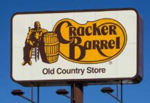 Culture War MELTDOWN At Cracker Barrel Cracker Barrel roadside sign with logo against blue sky