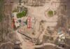 Russia-Iran Link Puts U.S. Bases In Crosshairs Aerial view through drone HUD of archaeological ruins and surrounding campsite
