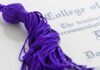 Culture War Engulfs Campus — Trust Collapses Close-up of a purple graduation tassel next to a diploma