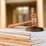 DOJ Blitz Nails Home Health Racket judge's gavel resting on a stack of case files