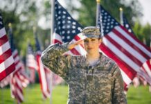 Six-Figure War Bonuses Roll Out Soldier saluting among American flags