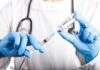 Private Fauci Miscarriage Warning Jolts Washington Healthcare worker drawing vaccine from vial with syringe