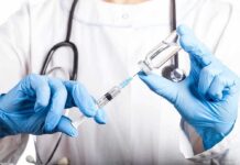 Private Fauci Miscarriage Warning Jolts Washington Healthcare worker drawing vaccine from vial with syringe