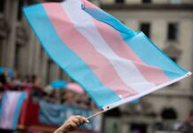 Transgender pride flag waving at a parade
