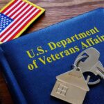 VA’s Dragon Stunner Shakes Gun Debate VA folder with house keychain and US flag patch on wooden desk