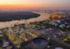 Industrial oil refinery complex beside a river at dusk