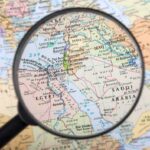 Magnifying glass over Middle East map