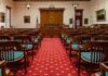 Courtroom with wooden benches facing the judge's bench