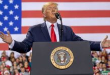 speaker at podium with U.S. flag backdrop