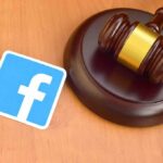 Judge's gavel next to a blue social media logo card