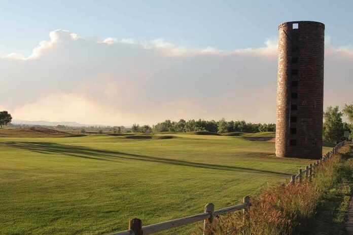 shutterstock_1719503803 Brick silo beside a golf course at sunset