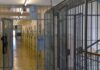 Prison corridor with barred doors