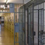 Prison corridor with barred doors
