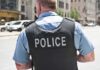 Police officer in uniform from behind on a city street