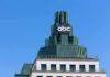 abc logo atop green-stepped building against clear blue sky