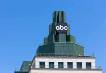 abc logo atop green-stepped building against clear blue sky