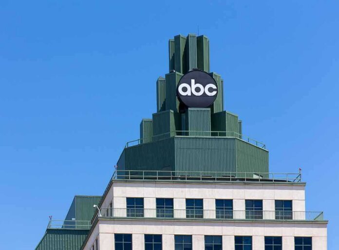 abc logo atop green-stepped building against clear blue sky