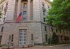 Stone government building with American flag at entrance