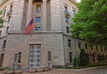 Taxpayer Heist Inside USDA Stone government building with American flag at entrance
