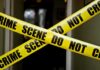 Priest Killed In Monastery Rampage Yellow crime scene tape crossing a doorway