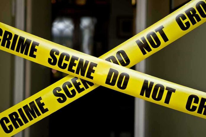 shutterstock_100885045-1 Yellow crime scene tape crossing a doorway