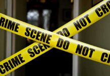 Kempton Park Killings Spark Serial Fears Yellow crime scene tape crossing a doorway