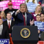 Culture War ERUPTS On Convention Stage politician speaking at a rally podium