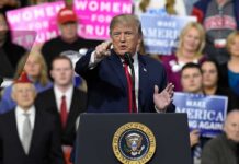 Culture War ERUPTS On Convention Stage politician speaking at a rally podium