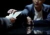 Hands exchanging cash across a table
