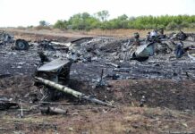 Airplane crash debris scattered across a burned field