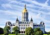 Connecticut State Capitol building with a golden dome and surrounding greenery
