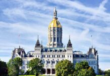 Trump-Backed Map Halted – Chaos Avoided Connecticut State Capitol building with a golden dome and surrounding greenery