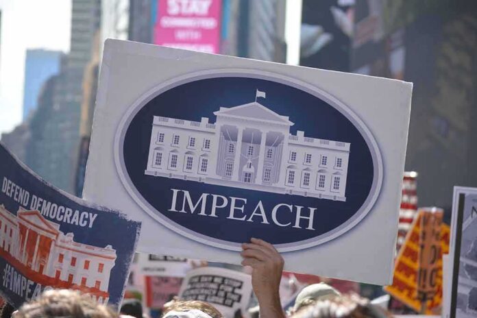 shutterstock_1529910779 Protest crowd holding an impeach sign with the White House emblem
