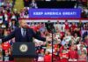Crowd at a political rally with a speaker at a podium; Stephen Paea, Curtis Lofton, Walter Jones, John Sullivan, and Colin David Jones present