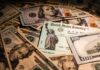 Jack Smith Took The Checks – Thousands United States Treasury check on a pile of US dollar bills