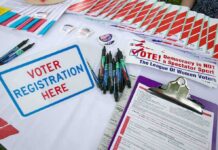 Volatile LA Race Upends Assumptions Voter registration table with forms, pens, and informational materials