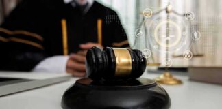 Judge's gavel on a desk with scales of justice in background