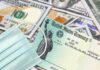U.S. Treasury check with face mask on pile of hundred-dollar bills