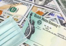 Election Shock Play: $500 Health Rebates U.S. Treasury check with face mask on pile of hundred-dollar bills