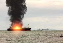 Blockade Drama: Tanker Stopped Cold Cargo ship on fire with thick black smoke at sea