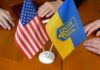 Moscow Balks, Kyiv Dangles Relief U.S. and Ukrainian flags on a table