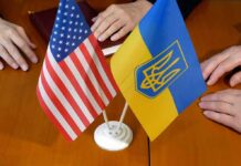 Moscow Balks, Kyiv Dangles Relief U.S. and Ukrainian flags on a table