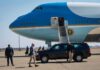 Press Pool Meltdown Over Air Force One Security detail near blue and white aircraft with staircase and SUV