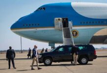 Press Pool Meltdown Over Air Force One Security detail near blue and white aircraft with staircase and SUV