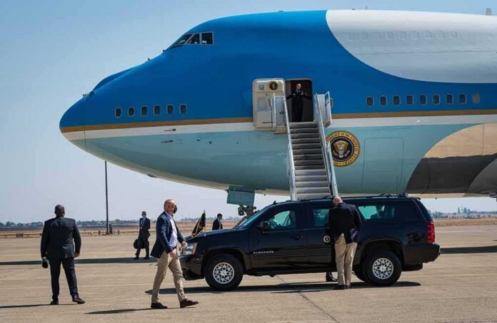 shutterstock_2047086128-1 Security detail near blue and white aircraft with staircase and SUV