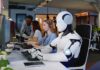China’s Robot March Begins Robot and office workers at computers in a modern workspace