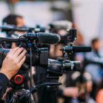 Anti-Aging Pill Hype Crumbles Video cameras on tripods at a media event