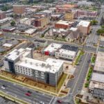 Global Birthrate Collapse: A Looming Threat? Aerial view of a downtown city block with streets and mixed-use buildings