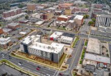 Aerial view of a downtown city block with streets and mixed-use buildings