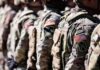 NATO Line Hardens – New U.S. Battalion Arrives Soldiers in camouflage uniforms standing in formation